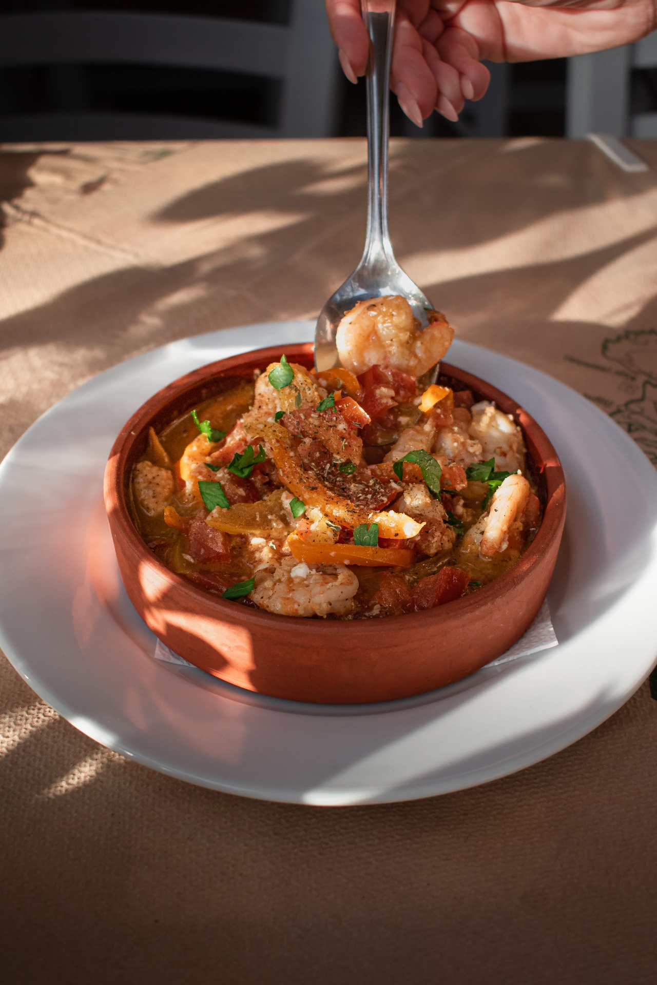 Shrimp saganaki in a clay dish