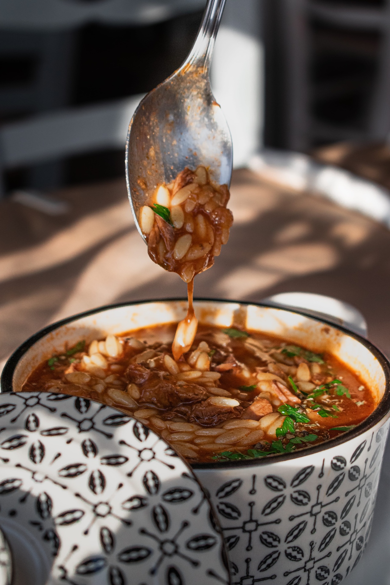Orzo and meat falling from the spoon